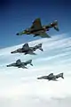 An air-to-air left underside view of four 37th Tactical Fighter Wing F-4E Phantom II aircraft in formation during the Tactical Air Command bombing and gunnery competition Gunsmoke '85 DF-ST-87-03762