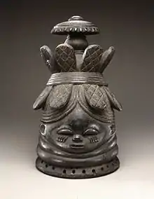 Helmet mask (ndoli jowei) for Sande society; late 19th-early 20th century; wood; 39.4 x 23.5 x 26 cm (151⁄2 x 91⁄4 x 101⁄4 in.); Brooklyn Museum (New York City). A vertical crack runs from base of mask to head band at back center and includes a triangular 13⁄4 hole below band