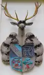 Crest of the fraternity Corps Hubertia Freiburg with a Zirkel in the upper right. This crest is a wall display on the outside of a fraternity house.