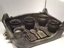 Clay replica of a serving tray (foculum) made for furnishing an Etruscan grave. The original tray and utensils may have been made of wood, metal, or other materials. Chiusi, Tomb A Group, 550-500 BCE.