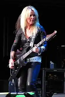 Lita Ford playing a guitar onstage