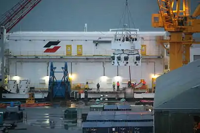 The repaired and improved containment dome is hoisted onto the Arctic Challenger prior to leaving for testing.