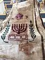 Parochet with the emblem of the State of Israel, Menorah, and olive tree branches with leaves.