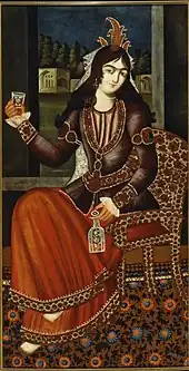 Woman holding a bottle and a glass.