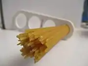 Dried spaghetti measured with a &quot;spaghetti measure&quot;. One portion of dried pasta weighs 116&nbsp;g (4+1⁄8&nbsp;oz), twice the amount of one serving on the package (12&nbsp;mm circle or 60&nbsp;g.). The measure can portion out 1, 2, 3, or 4 servings based on the diameter of the circle.