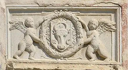 Relief with the coat of arms of Moldavia in a laurel wreath hold by two cherubs (aka putti), above the pisanie of the Saint Demetrius of Thessaloniki Church, Suceava, unknown sculptor, 1534