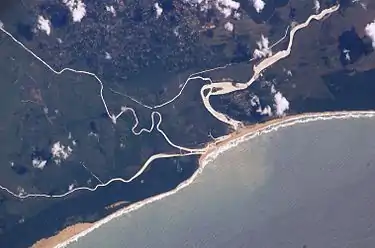 The old and new courses near the mouth, with the Msunduzi converging from the left (i.e. south), enclosing a wetland. Also note the silt plume at sea.