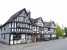 A large half-timbered pub building with three gables