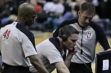 Image 17NBA officials Monty McCutchen (center), Tom Washington (#49) and Brent Barnaky reviewing a play. (from Official (basketball))