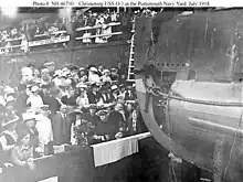 Wood (in white uniform at lower left) attends the christening of the submarine USS&nbsp;O-1, 9 July 1918.