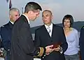 The Montenegro Minister of Defense and a U.S. Navy officer exchange gifts in 2007 during a reception to mark the first year of Montenegro's independence.