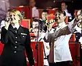 Jessica Hatfield, a vocalist with the United States Navy 7th Fleet Band (left), and Tanya Christensen, a vocalist with Australian Army Band Brisbane singing Waltzing Matilda at a concert.