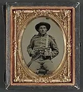 Private William Anthony Holland of Co. K, with Bowie knife and Colt Army Model 1860 revolver