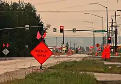 Van Horn Road westbound at South Cushman Street in June 2012.  In the background is a portion of the business district which runs along the CDP's northern edge.