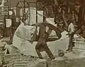 Workers setting rough stone in place, 1899.