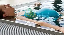 Woman floating in the edge of a pool