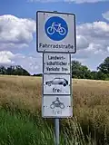 Additional panels below this bike road sign permit usage by agricultural traffic, cars and motorbikes