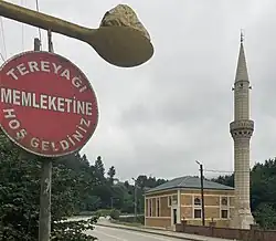 Sign reading "Welcome to butter country" below a giant spoon of butter